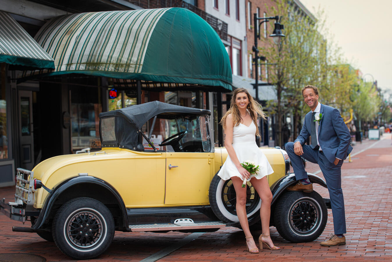 two adults pose with a classic car on church street in burlington, vermont. Photo by Paul Detzer.